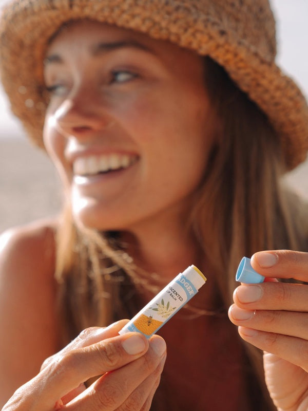 Woman holding Badger Unscented Lip Balm