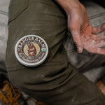 Badger Unscented Healing Balm beside work-worn hands