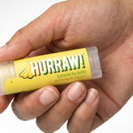 Hand holding Hurraw! Organic Lip Balm - Banana with Baobab 4.8g