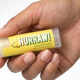 Hand holding Hurraw! Organic Lip Balm - Banana with Baobab 4.8g