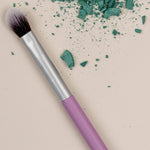 Benecos Blending Brush arranged diagonally beside crushed teal eyeshadow pigment.