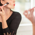 Model applying blush with a brush for Benecos Beauty ID Palette Blush Refill in Tuscany Please.