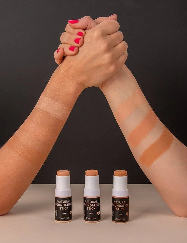 Foundation Stick shade swatches across two forearms with three Benecos Natural Foundation Stick bottles below.