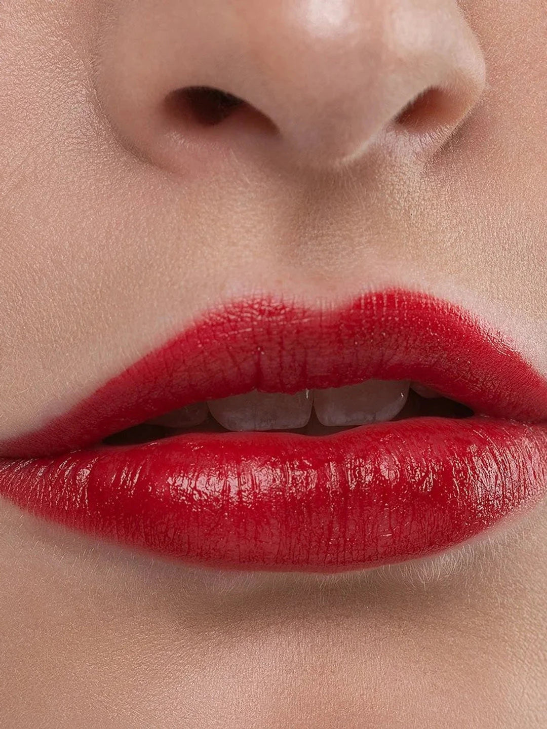 Close-up of slightly parted lips wearing Benecos Jumbo Lipstick in Cherry Lady, showing a rich cherry-red colour with a glossy sheen.