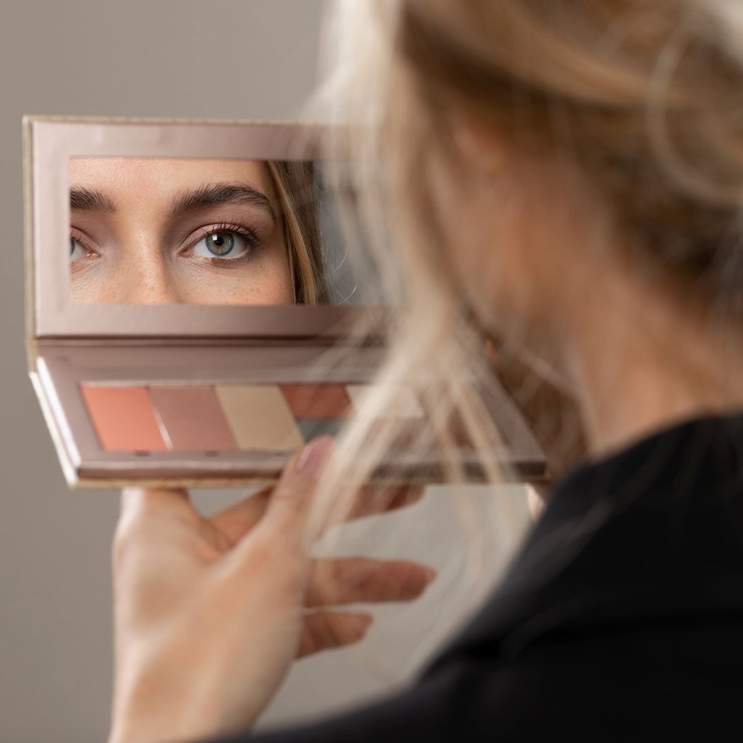 Model holding a Benecos Beauty ID Palette