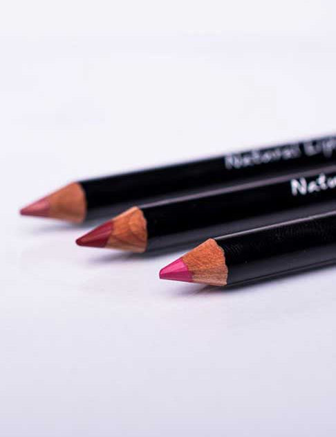 Three Benecos Natural Lipliners 1.13g, featuring black barrels and assorted pink and red tips, are arranged diagonally on a white surface.