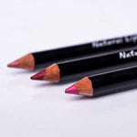 Benecos Natural Lipliner pencils in nude, red and bright pink arranged diagonally on a pale background.