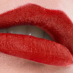 Close-up of lips wearing a rich red shade of Benecos MAT Lipstick.