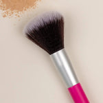 Benecos Powder Brush arranged diagonally beside loose beige powder on a cream background.