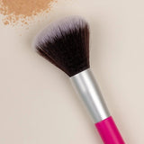Benecos Powder Brush arranged diagonally beside loose beige powder on a cream background.