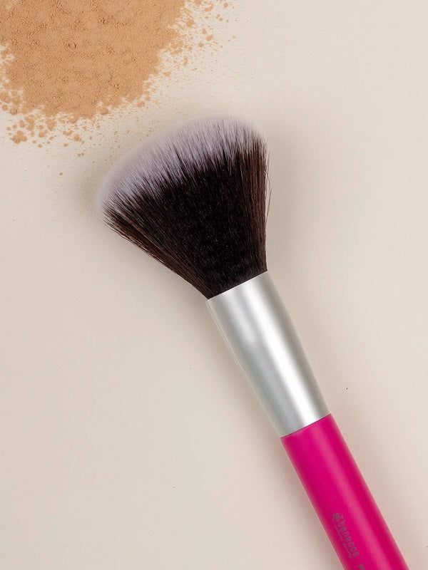 Benecos Powder Brush arranged diagonally beside loose beige powder on a cream background.