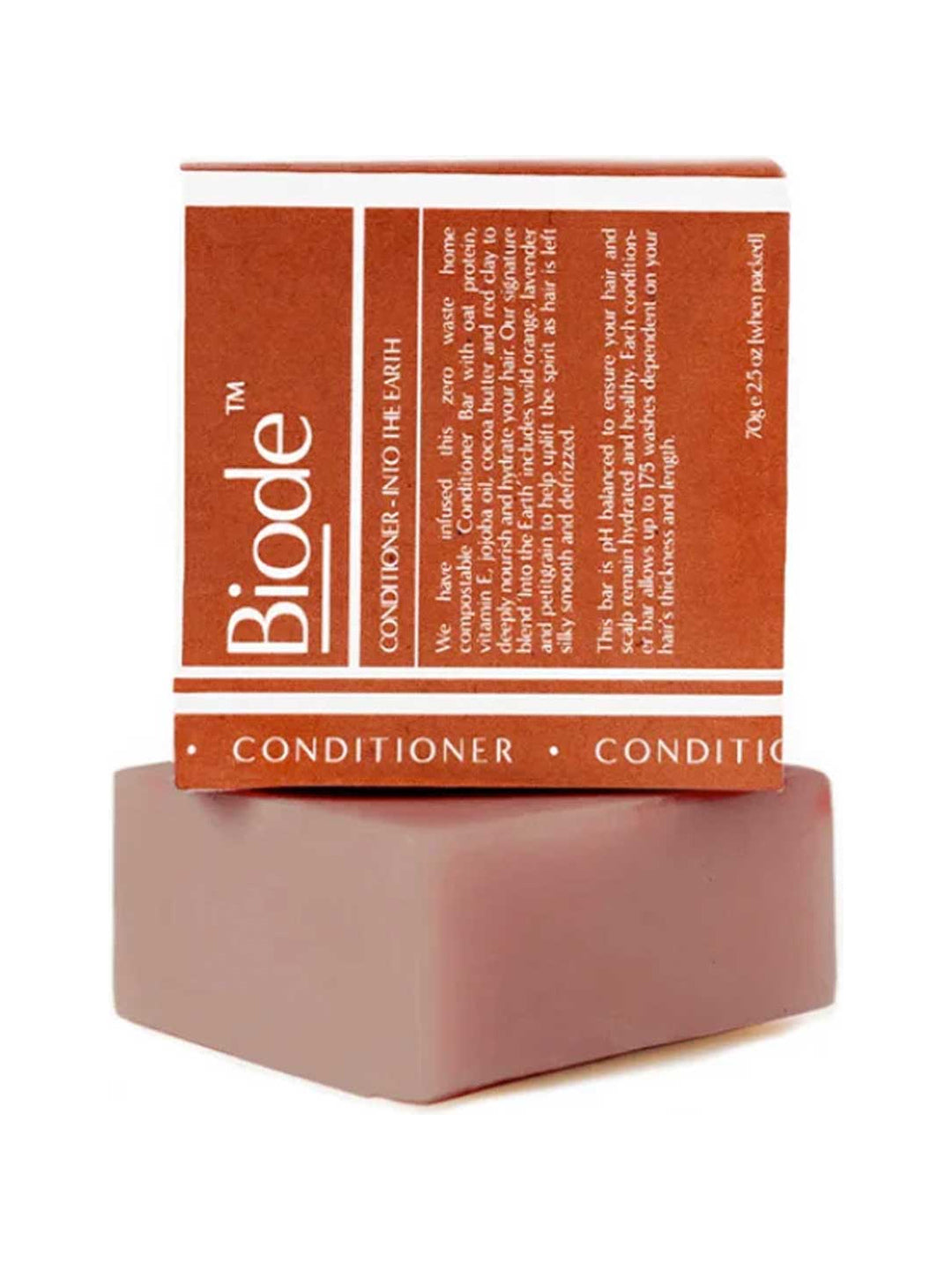 Dusty pink rectangular Biode Into the Earth conditioner bar beneath a terracotta carton printed with white lines and lettering.