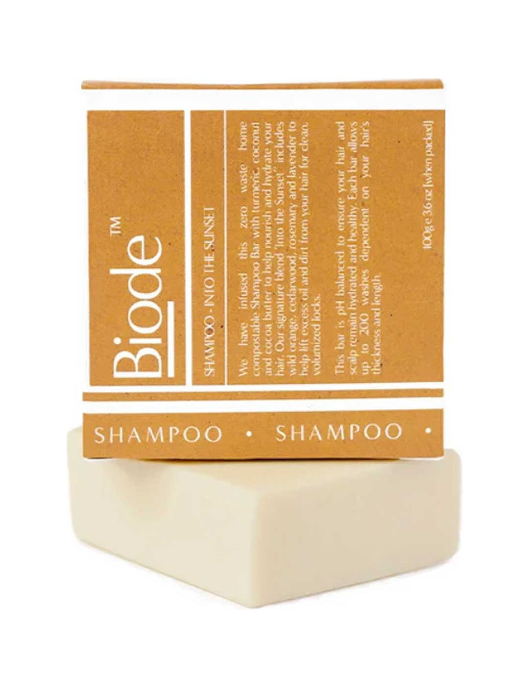 Cream-coloured rectangular Biode Into the Sunset shampoo bar beneath a mustard yellow carton printed with white lines and lettering.