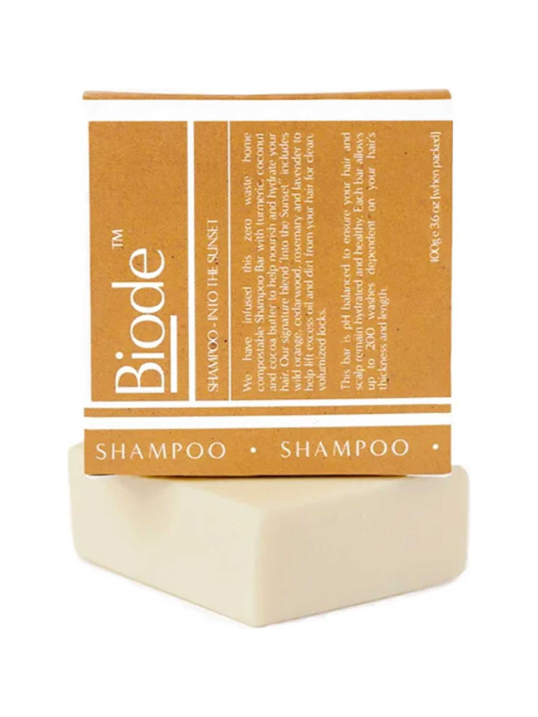 Cream-coloured rectangular Biode Into the Sunset shampoo bar beneath a mustard yellow carton printed with white lines and lettering.