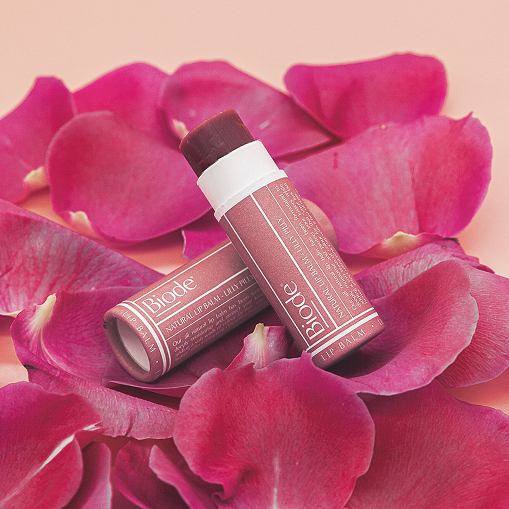 Biode Lilly Pilly Tinted Lip Balm styled with rose petals