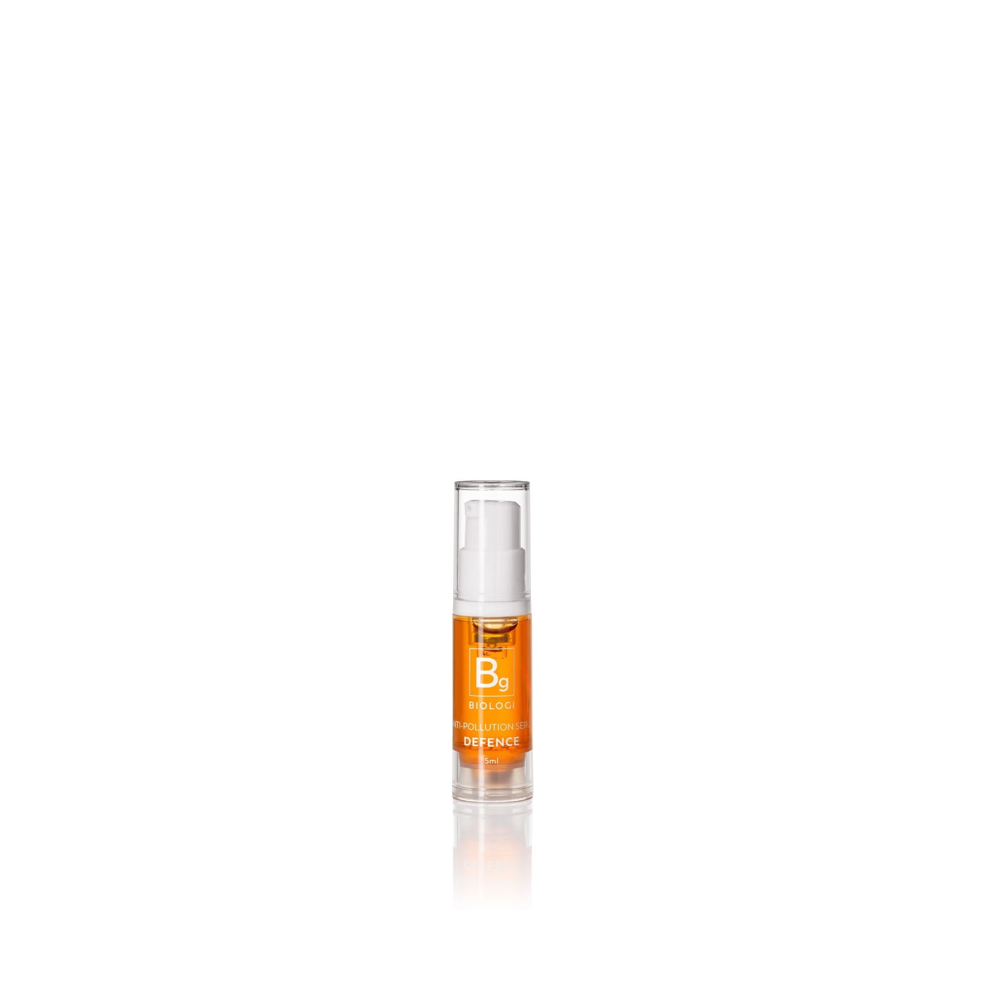 Biologi Bg Defence Anti-Pollution Serum 5ml mini in a clear pump bottle with golden-orange serum and a Bg label, standing on white with a faint reflection.