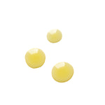 Three glossy pale yellow drops of Biologi Br Rosehip Oil on white, showing the oil's colour and fluid texture.