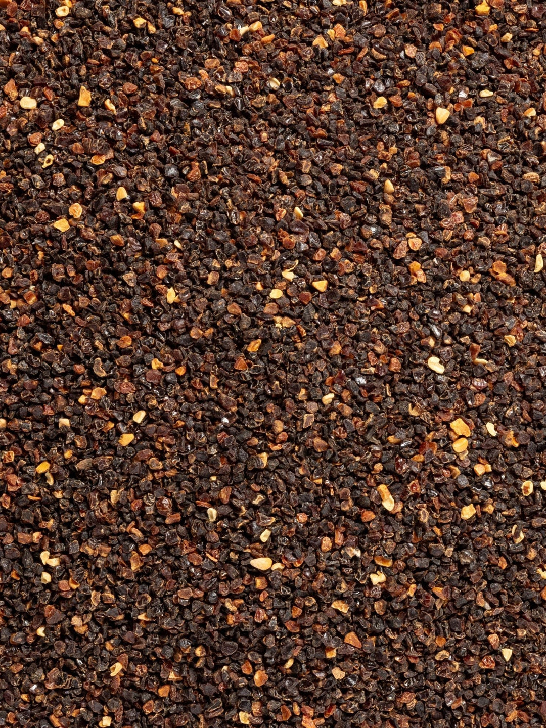 Close-up of finely textured brown and orange rosehip material, photographed as the botanical ingredient image for Biologi Br Rosehip Oil.