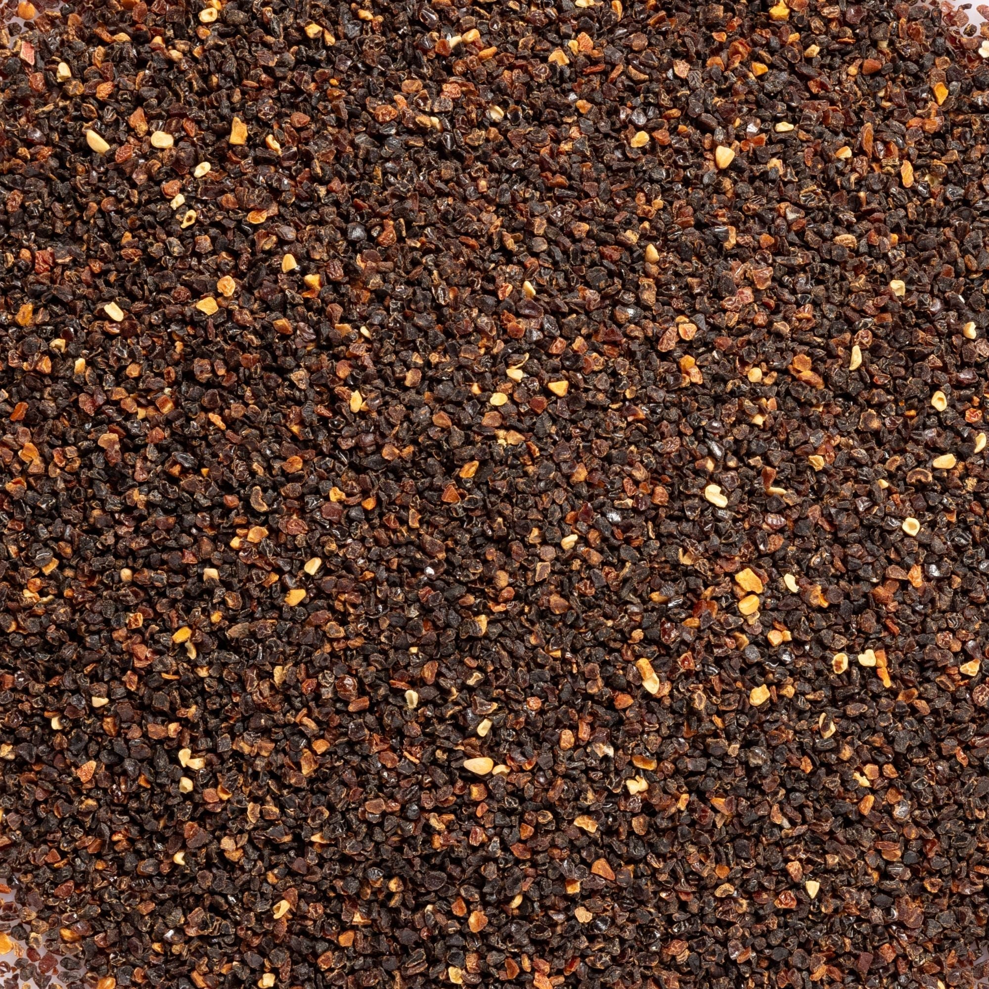 Close-up of finely textured brown and orange rosehip material, photographed as the botanical ingredient image for Biologi Br Rosehip Oil.