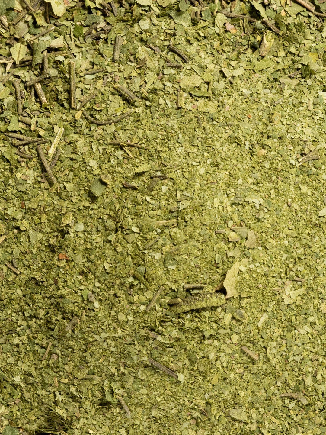 Close-up of green powdered and crushed kawakawa leaves, the botanical ingredient image for Biologi Hydra Balance Bio Cellulose Sheet Mask.