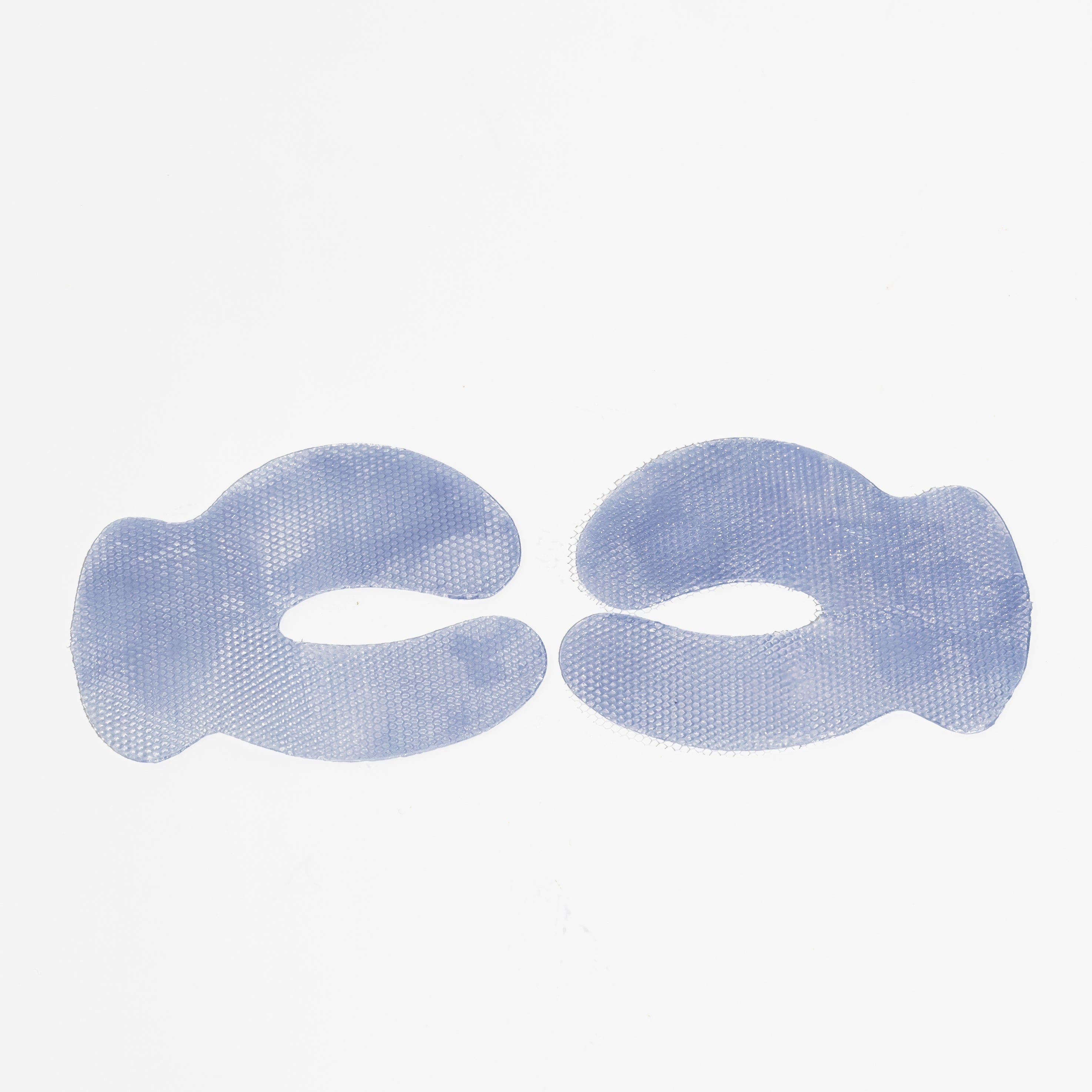 Two lavender-blue Biologi Revive Bio Cellulose Eye Mask patches laid flat on white, showing their curved shape, eye openings and woven texture.