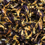 Close-up of dried blue-purple butterfly pea flowers mixed with pale stems, the botanical ingredient featured in Biologi Revive Bio Cellulose Eye Mask.