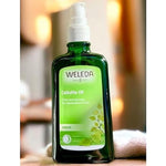 Weleda Birch Cellulite Oil bottle on a natural wooden surface