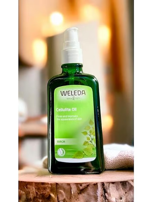 Weleda Birch Cellulite Oil bottle on a natural wooden surface