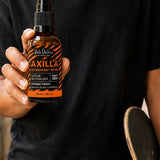 Black Chicken Remedies Axilla Orange Crush Deodorant Spray — held in hand