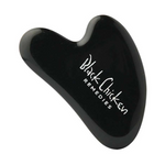 The Black Chicken Remedies Black Obsidian Gua Sha is a sleek black facial massage tool with the brand name in white text, inspired by Traditional Chinese Medicine and shown against a plain white background.