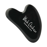 The Black Chicken Remedies Black Obsidian Gua Sha is a sleek black facial massage tool with the brand name in white text, inspired by Traditional Chinese Medicine and shown against a plain white background.