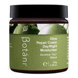 Botani Olive Repair Cream in a wide amber jar with a black screw lid and an olive-green label topped with a photograph of olives.