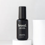 Black Breed Happy Hound Canine Cologne bottle displayed upright on a white studio plinth.