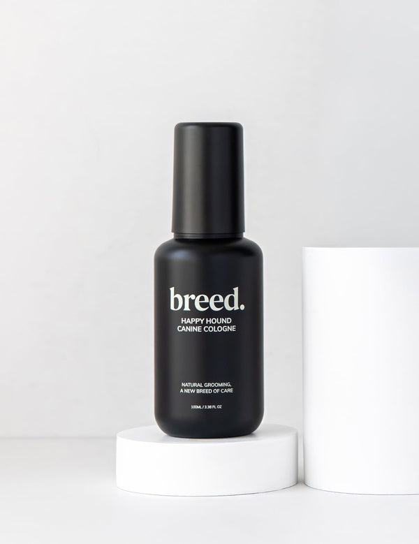 Black Breed Happy Hound Canine Cologne bottle displayed upright on a white studio plinth.