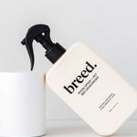 Breed Room Spray and Pet Bed Deodoriser bottle displayed at an angle against white studio plinths.
