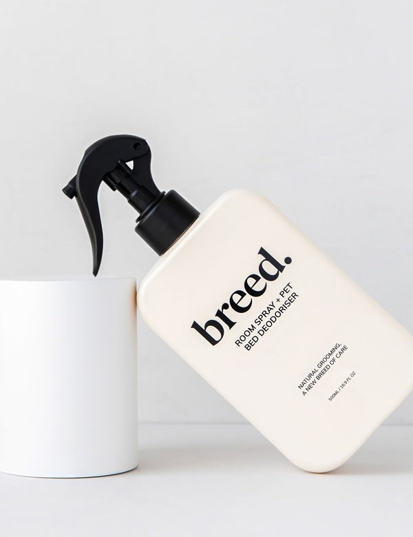 Breed Room Spray and Pet Bed Deodoriser bottle displayed at an angle against white studio plinths.