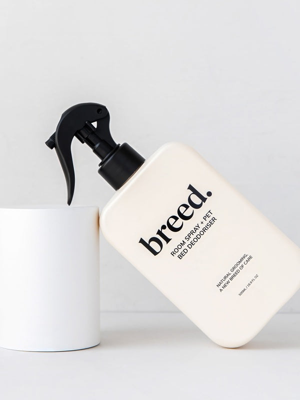 Breed Room Spray and Pet Bed Deodoriser bottle displayed at an angle against white studio plinths.