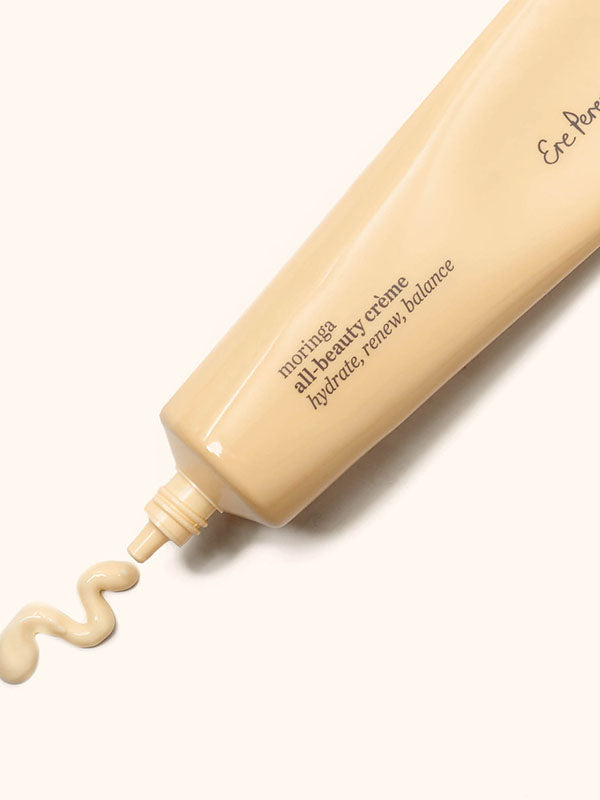Ere Perez Moringa All-Beauty Creme tube with a swirl of cream on a soft cream background