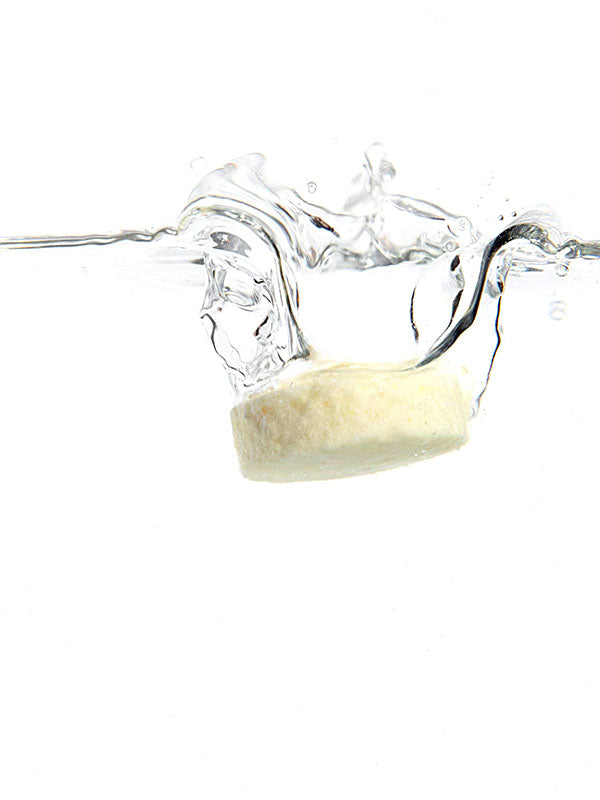 Ere Perez Ginkgo Micellar Cleanser tablet splashing into water on a white background