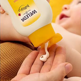 Weleda Calendula Body Lotion being dispensed before application to a baby.