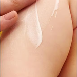 Weleda Calendula Body Lotion gently applied to a baby's leg.