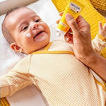 Applying Weleda Calendula Face Cream to baby's cheek