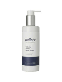 A white pump bottle labeled Juniper Calming Face and Body Wash 250ml with a blue accent. This natural, soap-free formula is ideal for dry or sensitive skin and helps soothe irritation.