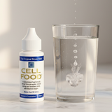 Cellfood Original Concentrate beside a glass of water as drops disperse