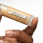 Hand holding Hurraw! Organic Lip Balm - Chai Spice 4.8g