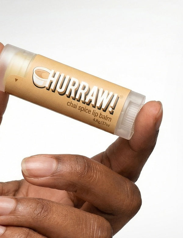 Hand holding Hurraw! Organic Lip Balm - Chai Spice 4.8g