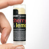 Hand holding Hurraw! Cherry & Lemon Lip Balm 4.8g