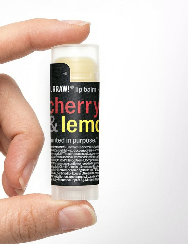 Hand holding Hurraw! Cherry & Lemon Lip Balm 4.8g
