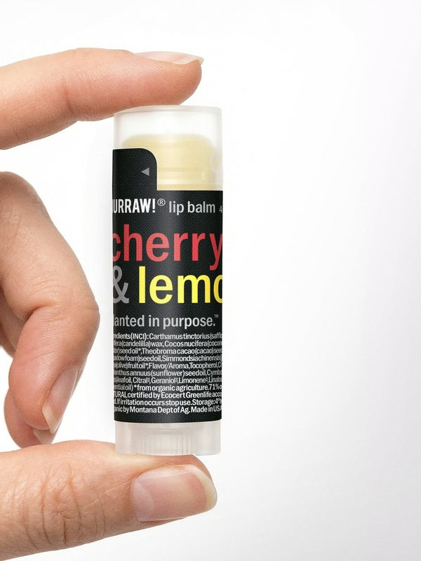 Hand holding Hurraw! Cherry & Lemon Lip Balm 4.8g