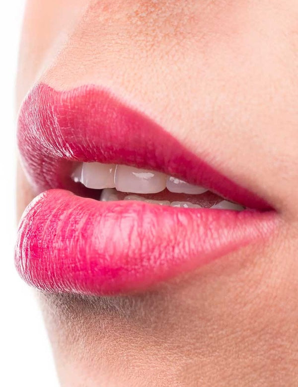 Close-up of glossy bright cherry lips wearing 100% Pure Cherry Lip & Cheek Stain.